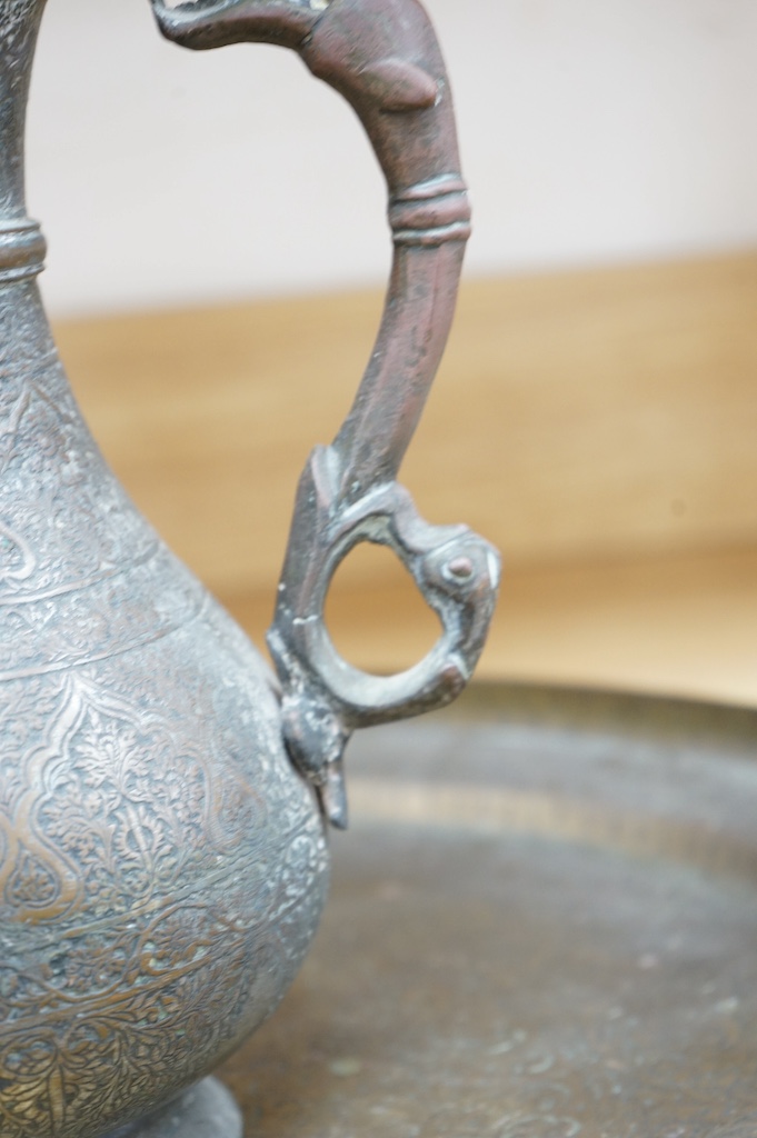 A Kashmiri brass lidded tea pot and tray, teapot 35cm high, tray 50cm diameter. Condition - fair to good
